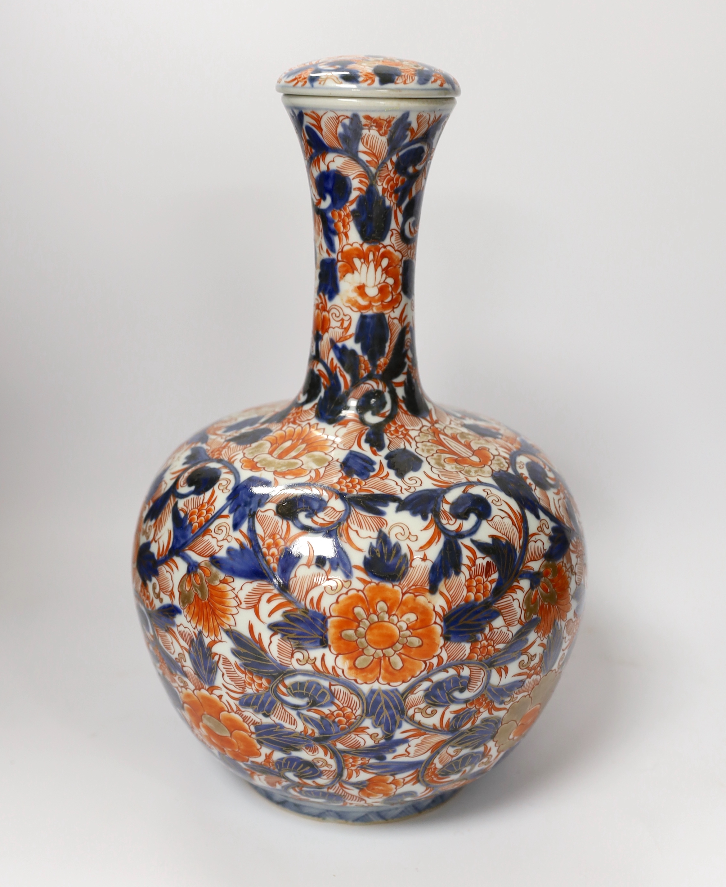 A pair of Chinese blue and white crackleware vases and covers and an Imari vase and cover, largest 31cm high